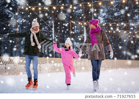 happy family at outdoor skating rink in winter happy family at outdoor skating rink in winter 71927655