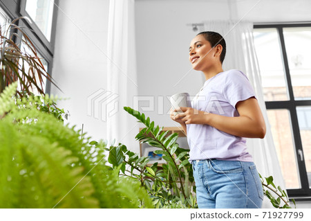 woman with coffee looking out window woman with coffee looking out window 71927799