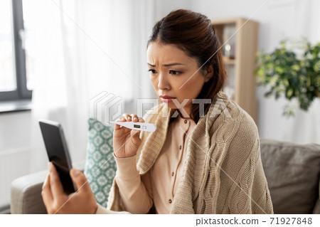 sick woman having video call on smartphone 71927848