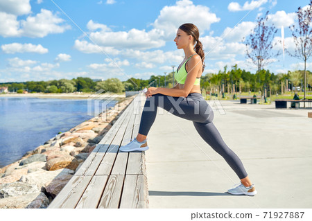 happy young woman doing sports and stretching leg happy young woman doing sports and stretching leg 71927887