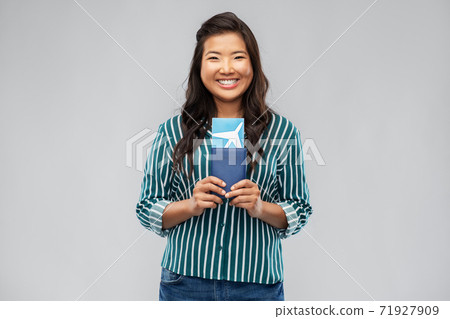 happy asian woman with air ticket and passport 71927909