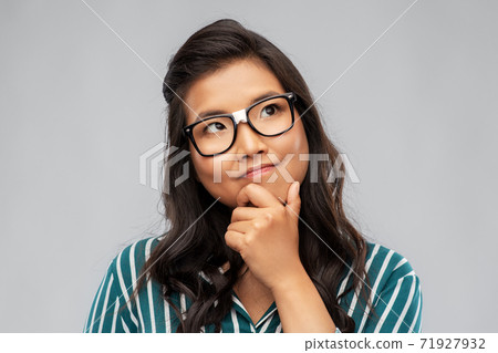 portrait of thinking asian woman in glasses portrait of thinking asian woman in glasses 71927932