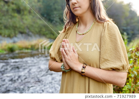 woman or witch performing magic ritual on river 71927989