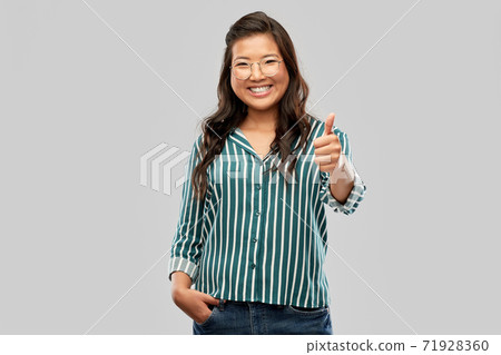 happy asian woman in glasses showing thumbs up happy asian woman in glasses showing thumbs up 71928360