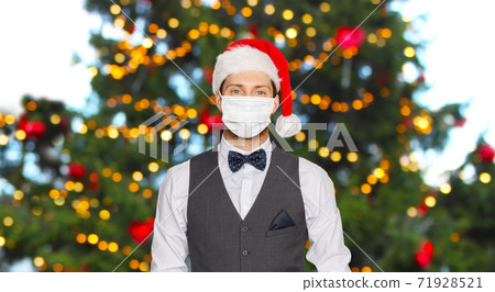 man in protective masks and santa hat on christmas man in protective masks and santa hat on christmas 71928521