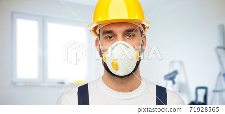 male worker or builder in helmet and respirator 71928565