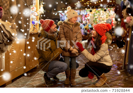 happy family at christmas market in city 71928844