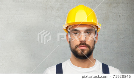 male worker or builder in helmet and overall male worker or builder in helmet and overall 71928846