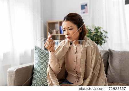 sick asian woman with nasal spray medicine at home sick asian woman with nasal spray medicine at home 71928867