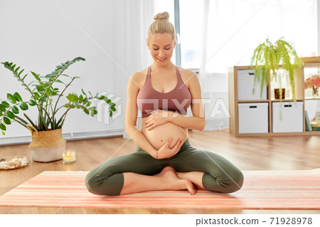 happy pregnant woman doing yoga at home happy pregnant woman doing yoga at home 71928978