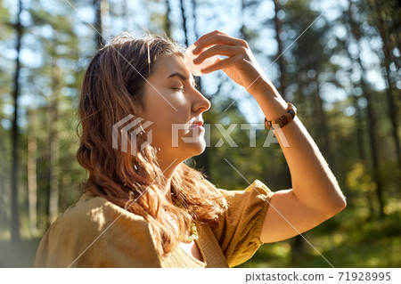 woman or witch performing magic ritual in forest 71928995