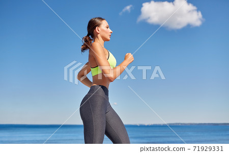 young woman running at seaside young woman running at seaside 71929331