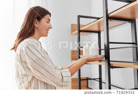 woman decorating home with candles woman decorating home with candles 71929332