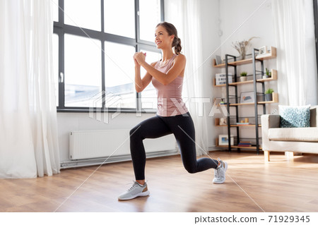 young woman exercising at home 71929345