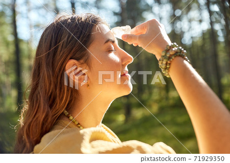woman or witch performing magic ritual in forest woman or witch performing magic ritual in forest 71929350