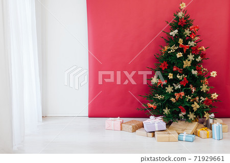 christmas tree with colorful balls and gift boxes over white wall 71929661