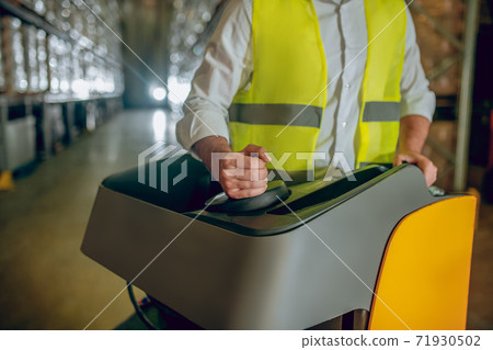 Close up picture of worker in a warehouse Close up picture of worker in a warehouse 71930502