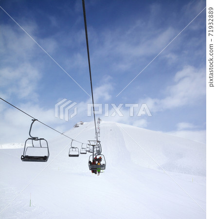 Chair-lift, snow ski slope and cloudy sky with falling snow Chair-lift, snow ski slope and cloudy sky with falling snow 71932889