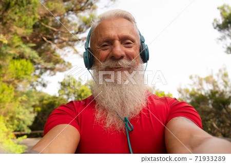 Bearded senior using mobile phone outdoor Bearded senior using mobile phone outdoor 71933289