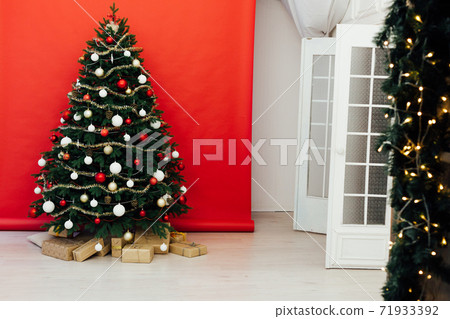 December Christmas tree pine with gifts new year interior decor December Christmas tree pine with gifts new year interior decor 71933392