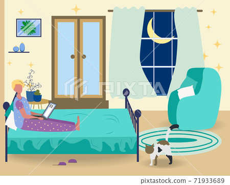 A man in pajamas works on a laptop at home in the bedroom on the bed. Freelance concept, quarantine due to covid-19 71933689