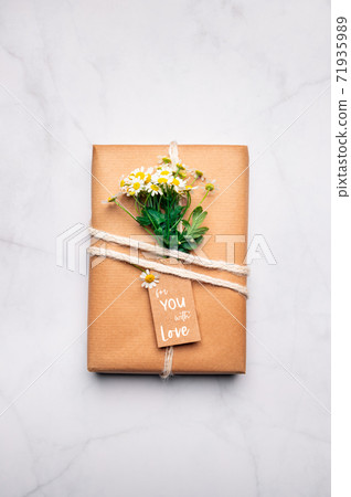 Eco friendly gift wrapped in brown paper 71935989