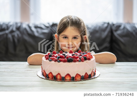 Little girl birthday cake.Home made cake with berries. Cake with Strawberry, blackberry, blueberry, and raspberry on a table 71936248