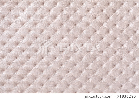 Texture of pearl beige leather background with capitone pattern, macro. Texture of pearl beige leather background with capitone pattern, macro. 71936289