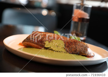 Sea bass fillet with pesto sauce 71936410