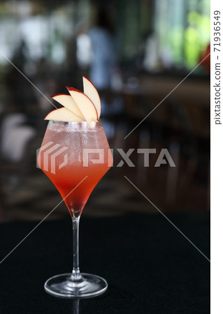 Pink Cocktail glass with ice at a bar counter 71936549