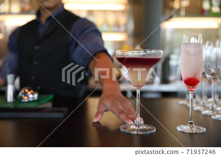 cocktails in glasses on bar counter in pup or restaurant 71937246