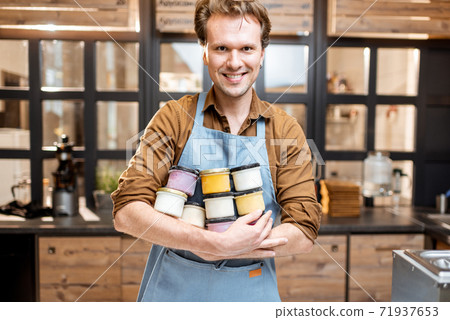 Salesman with ice cream in the shop Salesman with ice cream in the shop 71937653