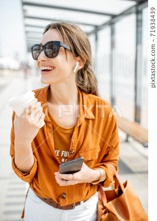Portrait of a business woman at the transport stop Portrait of a business woman at the transport stop 71938439