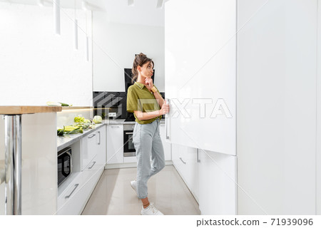 Woman cooking on the white kitchen 71939096