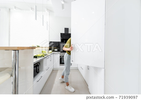 Woman cooking on the white kitchen 71939097