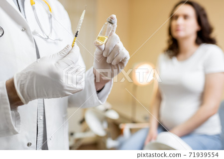 Doctor holding vaccine or some medication in the syringe Doctor holding vaccine or some medication in the syringe 71939554