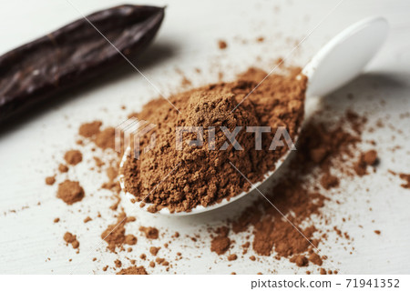 carob powder and ripe carob pod carob powder and ripe carob pod 71941352