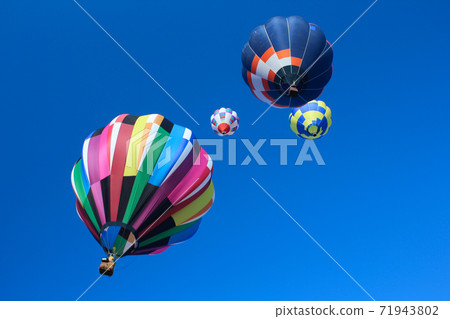Colorful gas balloon that shines in the blue sky 71943802