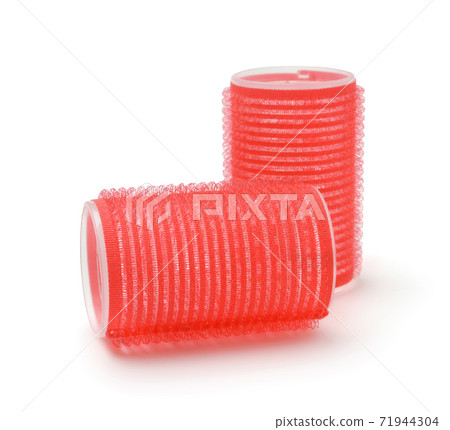 Red hair curlers isolated on white. 71944304
