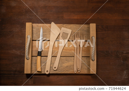 Kitchen wooden utensils on wooden table horizontal banner layout. Top view on wooden table background Kitchen wooden utensils on wooden table horizontal banner layout. Top view on wooden table background 71944624