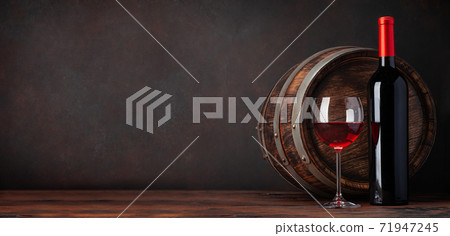 Wine bottle and old wooden barrel Wine bottle and old wooden barrel 71947245