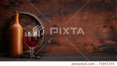 Wine bottle and old wooden barrel Wine bottle and old wooden barrel 71947254
