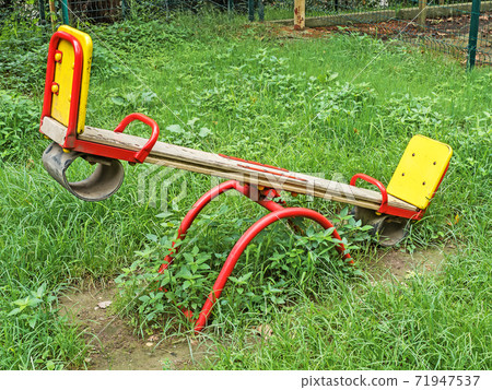 Children's swing balancer on green grass on street Children's swing balancer on green grass on street 71947537