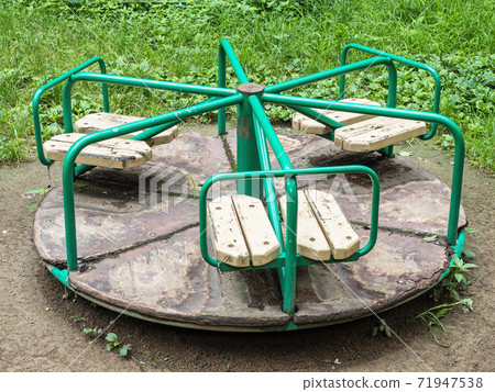 Round green swing in the playground on street Round green swing in the playground on street 71947538