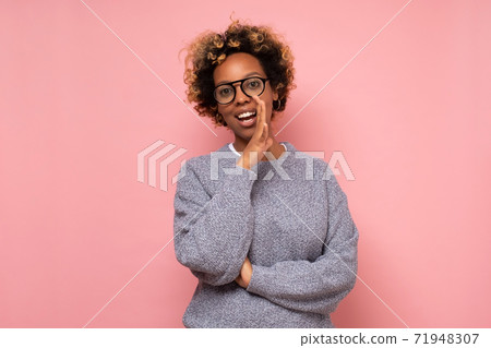 Young african american woman with hand on mouth telling secret rumor Young african american woman with hand on mouth telling secret rumor 71948307