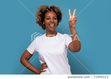 Young african woman showing two fingers, positive or peace gesture Young african woman showing two fingers, positive or peace gesture 71948323