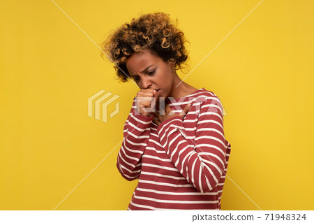 African american woman feeling unwell and coughing as symptom for cold or bronchitis. African american woman feeling unwell and coughing as symptom for cold or bronchitis. 71948324