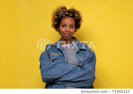 African young woman with shaggy hairstyle smiling cheerfully, feeling happy and carefree. African young woman with shaggy hairstyle smiling cheerfully, feeling happy and carefree. 71948325