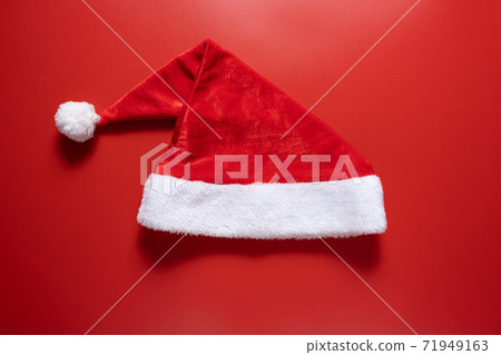Santa claus hat on a red background. Santa claus hat on a red background. 71949163