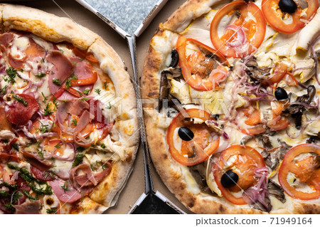 Two different pizzas in a box top view. Two different pizzas in a box top view. 71949164